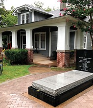 The grave of late author Alex Haley sits outside his former boyhood home in Henning, Tenn. The home is part of the Alex Haley Museum and Interpretive Center, which is honoring the writer of “Roots: The Saga of an American Family,” on what would be Mr. Haley’s 100th birthday.