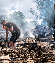 Josh Whitlock and Stacy Mathieson look through what is left of their home after it burned following flooding in Waverly, Tennessee.
Mandatory Credit:	Andrew Nelles/The Tennessean/AP