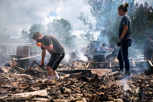 Josh Whitlock and Stacy Mathieson look through what is left of their home after it burned following flooding in Waverly, Tennessee.
Mandatory Credit:	Andrew Nelles/The Tennessean/AP