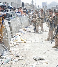 US Marines provide assistance during an evacuation at Hamid Karzai International Airport, Kabul, Afghanistan, on August 20.
Mandatory Credit:	US Marine Corps