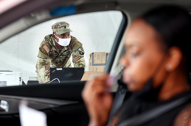 A driver administers a self-collected nasal swab at a Covid-19 drive-through testing site operated by the National Guard on August 11, in New Orleans, Louisiana.
Mandatory Credit:	Mario Tama/Getty Images