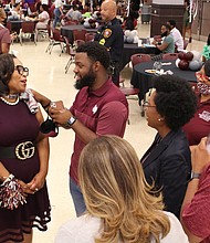 Dr. Young (left) enjoys a conversation with students and staff during the “Party with a Purpose”.

Photo by Andrew McCray