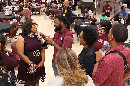 Dr. Young (left) enjoys a conversation with students and staff during the “Party with a Purpose”.

Photo by Andrew McCray