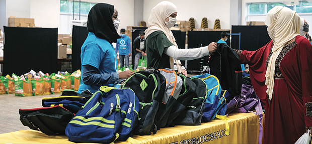 When the pencils, paper and notebooks come out, you know it’s time for school. Fosio Issack, left, and Jennah Elganainy, both 15, volunteer to help distribute backpacks filled with school supplies on a recent Saturday at ICNA Relief’s Back2School program. ICNA Relief is a national domestic relief organization that is part of the Islamic Circle of North America. The backpacks were distributed to children of all faiths and backgrounds in conjunction with Henrico County Public Schools. It was part of a national effort by the organization to equip 45,000 students with the essentials they need to succeed in the classrooms. The volunteer effort took place at the Islamic Center of Henrico/Al Falah on Impala Drive in the county. It was also the organization’s food distribution day. Volunteers packed bags of nutritious goods to be distributed as well.