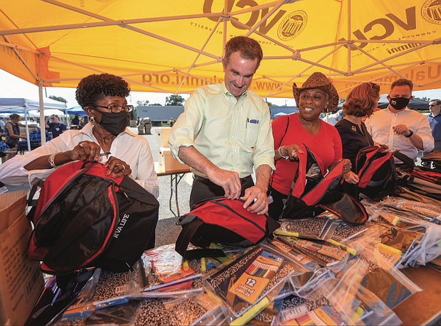 Efforts are in full swing to get youngsters ready for the start of classes in Richmond Public Schools. On Wednesday, Gov. Ralph S. Northam, second from left, and his wife, First Lady Pamela Northam, second from right, join Richmond city and school officials in filling new backpacks with school supplies at the Ultimate Backpack Supply Drive.
RPS partnered with CoStar Group, the VCU Alumni Association and Communities In School for the fourth annual event that took place at The Diamond on Arthur Ashe Boulevard. The goal was to collect up to 15,000 backpacks to give to city students as they return to in-person learning for the first time since March 2020.
With Gov. and Mrs. Northam are, from left, City Council President Cynthia I. Newbille, School Board Chairwoman Cheryl L. Burke and RPS Superintendent Jason Kamras.