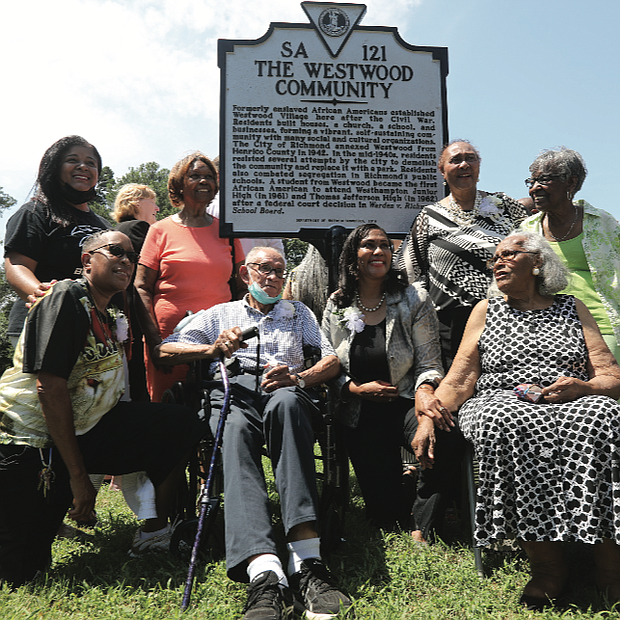 Current and former residents of Westwood celebrate last Sunday a new state historical marker honoring the community in Richmond’s West End that was started by formerly enslaved people following the Civil War. Location of marker: Willow Lawn Drive and Dunbar Street. 
Residents built homes, a church, a school and businesses, as well as social and cultural organizations in the community that originally was a part of Henrico County. It was annexed to Richmond in 1942 and residents later successfully fought attempts by city officials to demolish the community and replace it with a public park. Westwood Baptist Church remains the most prominent landmark. Kathleen Hopkins Valentine, 93, seated at right, is the oldest resident living in Westwood. She said she and her family moved when she was 4 from Philadelphia to what was then called Westwood Village. Others pictured here are, from left, Kelly Johnson Crowder, whose mother, Jane Cooper Johnson, integrated Westhampton Junior High and Thomas Jefferson High School in the early 1960s; Charlene Hopkins, kneeling, and Frances Bush Jones, both cousins of tennis great Arthur Ashe Jr., whose grandparents lived in Westwood; Warrick Taylor, a former Westwood resident; Norfolk State University professor Dr. Colita Nichols Fairfax, immediate past chair of the Virginia Board of Historic Resources, kneeling, and her mother, Brenda Dabney Nichols, who was born and raised in Westwood; and Lennie Anderson Thornton, a former Westwood resident. The Friends of Westwood Playground paid for the marker.