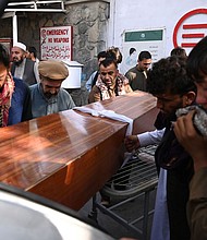 Relatives load in a car the coffin of a victim of the August 26th suicide attack, at a hospital in Kabul on August 27.
Mandatory Credit:	Aamir Qureshi/AFP/Getty Images