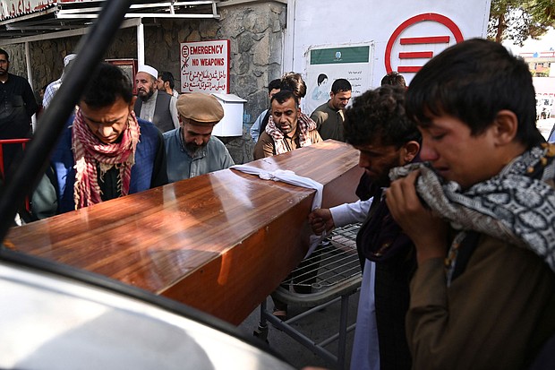 Relatives load in a car the coffin of a victim of the August 26th suicide attack, at a hospital in Kabul on August 27.
Mandatory Credit:	Aamir Qureshi/AFP/Getty Images