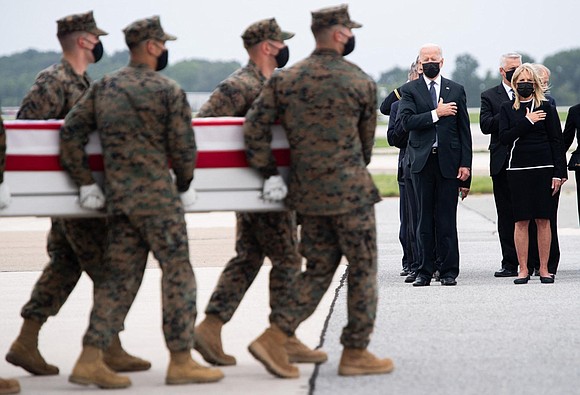 President Joe Biden watched stoically as flag-draped cases carrying the remains of American service members killed in Afghanistan returned Sunday …