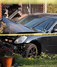 Police say an 18-year-old was found dead outside of this car, which slammed into two houses.
Mandatory Credit:	KSL