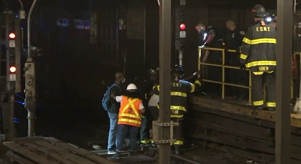 Stranded subway riders in New York had to walk on tracks in order to exit the station following a power outage on August 29.
Mandatory Credit:	WABC