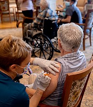 A healthcare worker administers a third dose of the Pfizer-BioNTech Covid-19 vaccine at a senior living facility in Worcester, Pennsylvania.
Mandatory Credit:	Hannah Beier/Bloomberg/Getty Images