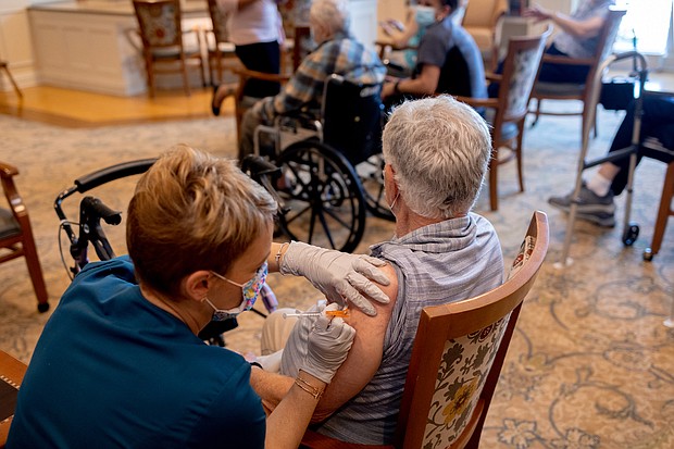 A healthcare worker administers a third dose of the Pfizer-BioNTech Covid-19 vaccine at a senior living facility in Worcester, Pennsylvania.
Mandatory Credit: Hannah Beier/Bloomberg/Getty Images