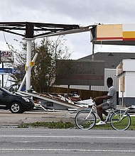 Hurricane Ida's direct hit on the nation's oil and gasoline industry could send gas prices higher. Pictured is damaged Shell station in Kenner, Louisiana, on August 30, after Hurricane Ida made landfall.
Mandatory Credit:	Patrick T. Fallon/AFP/Getty Images
