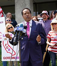 Larry Elder, pictured here on July 13, in California, vying to replace California Gov. Gavin Newsom, vows to repeal any mask or vaccine mandates for California's state workers if he is elected to replace the Democratic governor in the September 14 special election.
Mandatory Credit:	Marcio Jose Sanchez/AP