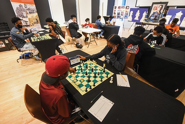 Checkmate! It was a race against the clock – and each other – during the Bright Minds RVA Chess Tournament, where a room full of area students matched wits last Friday, Aug. 27, at the Black History Museum and Cultural Center of Virginia. The tournament was the culmination of two weeks of classes taught by Fleming E. Samuels, a retired Richmond Public Schools administrator, and Dr. Theodore Andrews of Hampton University in a pilot program set up by the Bernice E. Travers Foundation. The inspiring group of 13- to 16-year-olds showed off the skills they learned during the tournament in which 14 students participated. Bottom photo, Binford Middle School student Jacory Oliver-Ray, 13, contemplates his next move, while, below, Franklin Military Academy student Ptah Ahmed, 13, left, faces off against Denzel Johnson, 14. Clinching the top three spots and prizes were Denzel Johnson; Jonathan Keel, 15, a student at Richmond Community High School; and Ptah Ahmed. (photo by Clement Britt)