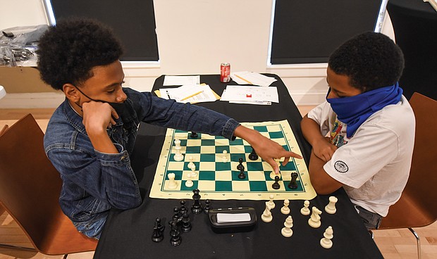 Checkmate! It was a race against the clock – and each other – during the Bright Minds RVA Chess Tournament, where a room full of area students matched wits last Friday, Aug. 27, at the Black History Museum and Cultural Center of Virginia. The tournament was the culmination of two weeks of classes taught by Fleming E. Samuels, a retired Richmond Public Schools administrator, and Dr. Theodore Andrews of Hampton University in a pilot program set up by the Bernice E. Travers Foundation. The inspiring group of 13- to 16-year-olds showed off the skills they learned during the tournament in which 14 students participated. Franklin Military Academy student Ptah Ahmed, 13, left, faces off against Denzel Johnson, 14. Clinching the top three spots and prizes were Denzel Johnson; Jonathan Keel, 15, a student at Richmond Community High School; and Ptah Ahmed. (photo by Clement Britt)