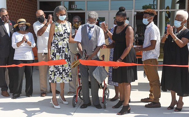 Henry L. Marsh III, Richmond’s first African-American mayor and a former state senator, cuts the ribbon at Saturday’s ceremony dedicating the new Richmond elementary school named in his honor. The school is located at 813 N. 28th St. Flanking Mr. Marsh are his daughter, Nadine Marsh-Carter, left, and Principal Kimberly Cook.