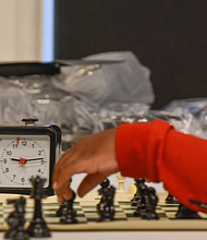 Checkmate! It was a race against the clock – and each other – during the Bright Minds RVA Chess Tournament, where a room full of area students matched wits last Friday, Aug. 27, at the Black History Museum and Cultural Center of Virginia. The tournament was the culmination of two weeks of classes taught by Fleming E. Samuels, a retired Richmond Public Schools administrator, and Dr. Theodore Andrews of Hampton University in a pilot program set up by the Bernice E. Travers Foundation. The inspiring group of 13- to 16-year-olds showed off the skills they learned during the tournament in which 14 students participated. Binford Middle School student Jacory Oliver-Ray, 13, contemplates his next move. Clinching the top three spots and prizes were Denzel Johnson; Jonathan Keel, 15, a student at Richmond Community High School; and Ptah Ahmed. (photo by Clement Britt)