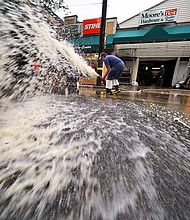 At least 8 people were killed after Ida slammed the Northeast with flash flooding and tornadoes. Water is pumped from the basement of a business on Noblestown road in Oakdale, Pennsylvania.
Mandatory Credit:	Gene J. Puskar/AP