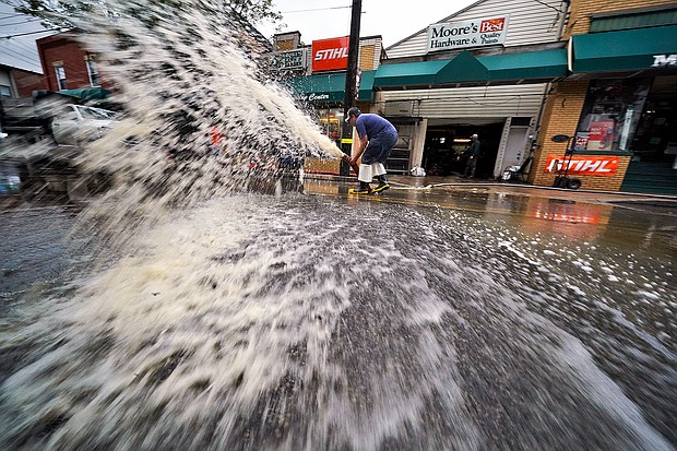 At least 8 people were killed after Ida slammed the Northeast with flash flooding and tornadoes. Water is pumped from the basement of a business on Noblestown road in Oakdale, Pennsylvania.
Mandatory Credit:	Gene J. Puskar/AP