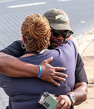 Devon Henry, president and chief executive officer of the Newport News-based Team Henry Enterprises, hugs his mother, Freda Thornton, after the Lee statue came down on Wednesday. Mr. Henry’s company was responsible for the removal and disassembly of the statue for storage in an undisclosed secure location. He faced death threats after his company’s role in removing Richmond’s other Confederate statues in July 2020 was made public.