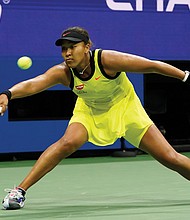 Naomi Osaka returns a shot to Leylah Fernandez of canada during the third round of the U.S. Open tennis championships last Friday in New York.