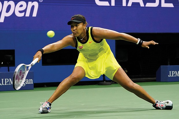 Naomi Osaka returns a shot to Leylah Fernandez of canada during the third round of the U.S. Open tennis championships last Friday in New York.
