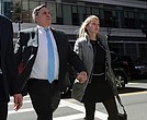 Investor John Wilson, left, arrives at federal court in Boston with his wife, Leslie, to face charges in a nationwide college admissions bribery scandal.