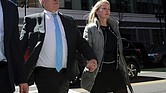 Investor John Wilson, left, arrives at federal court in Boston with his wife, Leslie, to face charges in a nationwide college admissions bribery scandal.