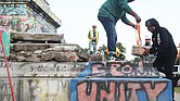 Devon Henry, whose company, Team Henry Enterprises, took down the Monument Avenue statue of Confederate Gen. Robert E. Lee, works with Grindly Johnson, Virginia’s secretary of administration, to place a new time capsule into the base around the pedestal.