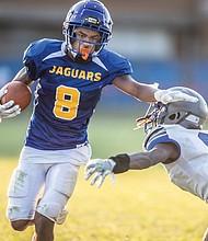 Armstrong High School’s Kile Artis gets past the John Marshall High defense to score a touchdown in last Friday’s game. The Armstrong Wildcats wore jerseys bearing the colors and mascot name – the Jaguars – of the former Armstrong-Kennedy High School Complex.