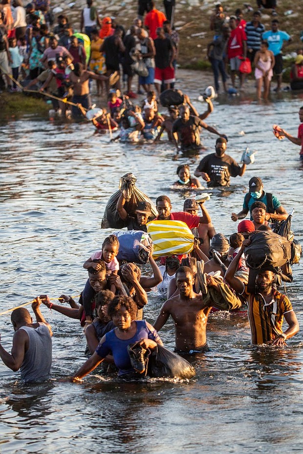 Haitian migrants cross the Rio Grande south into Ciudad Acuna from Del Rio, Texas, as they leave the migrant encampment underneath the Del Rio International Bridge after concerns of food scarcity and expulsions to Haiti on Monday Sept. 20, 2021.