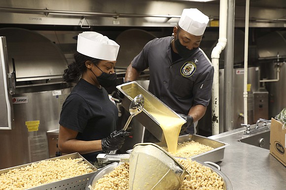 Operations Specialist Seaman Monika Riggins, left, from Houston, and Culinary Specialist 2nd Class Daquan Vereen, from Bethlehem, Pennsylvania, prepare food …
