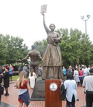 The monument was designed by Thomas Jay Warren of Oregon and shows a man, woman and child newly emancipated from enslavement. The man’s back is lined with scars from whipping and the woman is holding aloft a copy of the Emancipation Proclamation. The base contains the names and brief descriptions of 10 Virginians who contributed to the fight for freedom and equality before and after emancipation. They are slave rebellion leaders Gabriel and Nat Turner; Dred Scott, whose unsuccessful lawsuit for his freedom led to the 1857 U.S. Supreme Court decision declaring that people of African descent had no rights under the U.S. Constitution; William Harvey Carney, who fought with the Massachusetts 54th Infantry Regiment of the U.S. Colored Troops and was the first African-American to receive the Congressional Medal of Honor; and Mary Jane Richards Bowser, a spy in the Confederate White House in Richmond who provided useful information to Union officials. Also, the Rev. Wyatt Tee Walker, co-founder of the Southern Christian Leadership Conference and chief of staff to Dr. Martin Luther King Jr.; John Mercer Langston, Virginia’s first African-American representative in Congress; Lucy Simms, an teacher who advocated for universal education; John Mitchell Jr., the fiery newspaper editor of The Richmond Planet who led a boycott of Richmond’s segregated trolley system and was the first African-American to run for governor of Virginia; and Rosa Dixon Bowser, educator and women’s rights activist who founded the first African-American teachers association in Virginia and the Virginia State Federation of Colored Women’s Clubs.