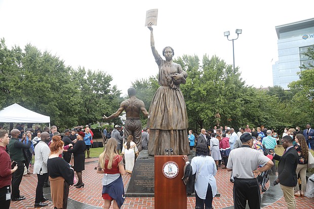 The monument was designed by Thomas Jay Warren of Oregon and shows a man, woman and child newly emancipated from enslavement. The man’s back is lined with scars from whipping and the woman is holding aloft a copy of the Emancipation Proclamation. The base contains the names and brief descriptions of 10 Virginians who contributed to the fight for freedom and equality before and after emancipation. They are slave rebellion leaders Gabriel and Nat Turner; Dred Scott, whose unsuccessful lawsuit for his freedom led to the 1857 U.S. Supreme Court decision declaring that people of African descent had no rights under the U.S. Constitution; William Harvey Carney, who fought with the Massachusetts 54th Infantry Regiment of the U.S. Colored Troops and was the first African-American to receive the Congressional Medal of Honor; and Mary Jane Richards Bowser, a spy in the Confederate White House in Richmond who provided useful information to Union officials. Also, the Rev. Wyatt Tee Walker, co-founder of the Southern Christian Leadership Conference and chief of staff to Dr. Martin Luther King Jr.; John Mercer Langston, Virginia’s first African-American representative in Congress; Lucy Simms, an teacher who advocated for universal education; John Mitchell Jr., the fiery newspaper editor of The Richmond Planet who led a boycott of Richmond’s segregated trolley system and was the first African-American to run for governor of Virginia; and Rosa Dixon Bowser, educator and women’s rights activist who founded the first African-American teachers association in Virginia and the Virginia State Federation of Colored Women’s Clubs.