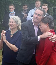 Many in the crowd, including state Sen. Jennifer L. McClellan, head of the statue commission, above, shed tears during the emotional ceremony. Sen. McClellan is comforted by Gov. Ralph S. Northam as Delegate Betsy B. Carr, left, applauds the unveiling.