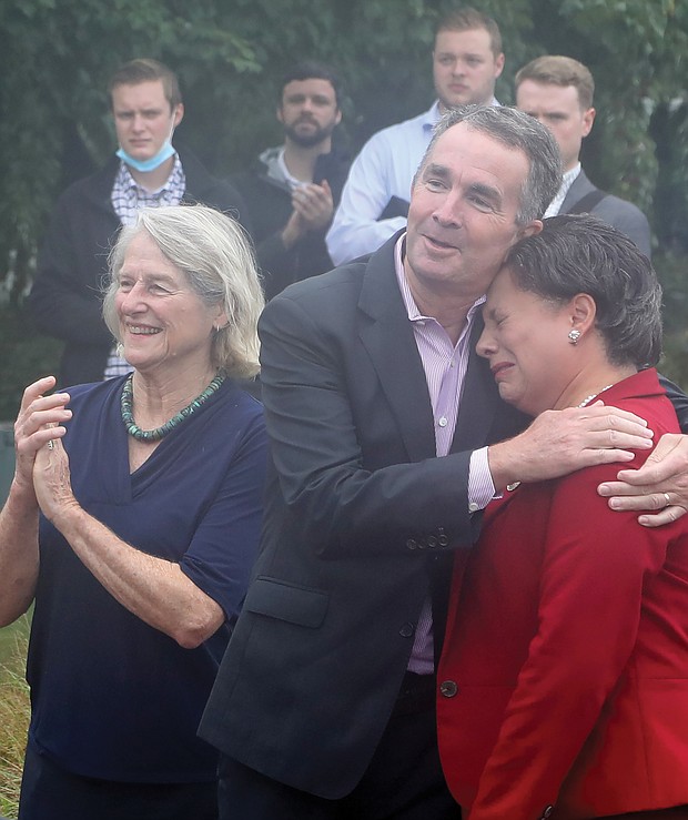 Many in the crowd, including state Sen. Jennifer L. McClellan, head of the statue commission, above, shed tears during the emotional ceremony. Sen. McClellan is comforted by Gov. Ralph S. Northam as Delegate Betsy B. Carr, left, applauds the unveiling.