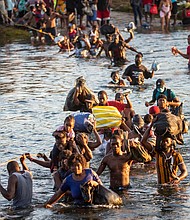 Haitian migrants cross the Rio Grande
