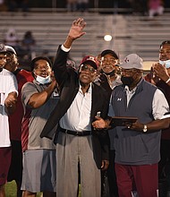 Former Panthers football Coach Willard Bailey waves to the crowd during a halftime ceremony where he was honored at the Willard Bailey Classic. At different times, Coach Bailey led the football programs at both VUU and its opponent last Saturday, Virginia University of Lynchburg. At right is Joe Taylor, VUU’s vice president of intercollegiate athletics and community wellness.