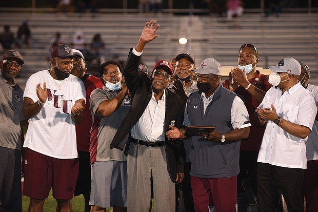 Former Panthers football Coach Willard Bailey waves to the crowd during a halftime ceremony where he was honored at the Willard Bailey Classic. At different times, Coach Bailey led the football programs at both VUU and its opponent last Saturday, Virginia University of Lynchburg. At right is Joe Taylor, VUU’s vice president of intercollegiate athletics and community wellness.