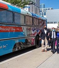 Harris County Commissioner Rodney Ellis, left, Mayor Sylvester Turner and Margaret Justus, founder of the Ann Richards Legacy Project, walk alongside Precinct One’s bus honoring Gov. Ann Richards after a news conference announcing the Ann Banners art project on Thursday.