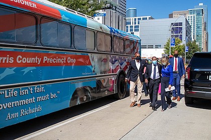 Harris County Commissioner Rodney Ellis, left, Mayor Sylvester Turner and Margaret Justus, founder of the Ann Richards Legacy Project, walk alongside Precinct One’s bus honoring Gov. Ann Richards after a news conference announcing the Ann Banners art project on Thursday.