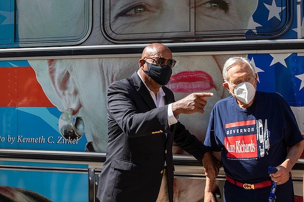 Harris County Commissioner Rodney Ellis, left, and Arthur L. Schechter, former U.S. Ambassador to the Commonwealth of The Bahamas, talk on side of the Gov. Ann Richards bus after a news conference announcing the Ann Banners art project on Thursday.