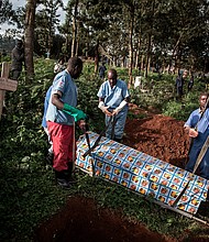 Health workers prepare to bury a coffin containing a victim of the ebola virus on May 16, 2019 in Butembo.
Mandatory Credit:	John Wessels/AFP/Getty Images