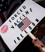 Anti-vaxxers are using the same tactics as cults do to attract followers on social media. In this image, anti-vaccine rally protesters hold signs outside of Houston Methodist Hospital in Houston, Texas, on June 26.
Mandatory Credit:	Mark Felix/AFP/Getty Images