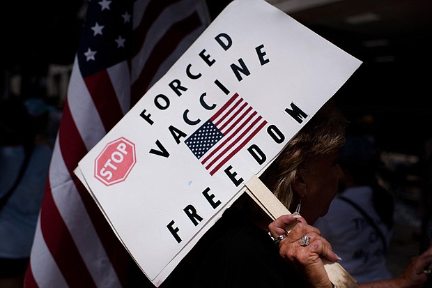 Anti-vaxxers are using the same tactics as cults do to attract followers on social media. In this image, anti-vaccine rally protesters hold signs outside of Houston Methodist Hospital in Houston, Texas, on June 26.
Mandatory Credit:	Mark Felix/AFP/Getty Images