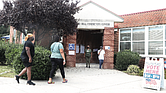 Richmonders heading into Hickory Hill Community Center on Tuesday are greeted by two poll workers outside the early voting location at 3000 E. Belt Blvd. in South Side. The community center and City Hall in Downtown opened Tuesday for early voting for the Nov. 2 election following action by the city Electoral Board. Voters also can cast ballots at the city Voter Registrar’s Office at 2134 W. Laburnum Ave.