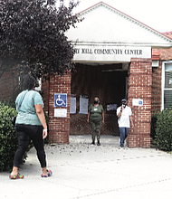 Richmonders heading into Hickory Hill Community Center on Tuesday are greeted by two poll workers outside the early voting location at 3000 E. Belt Blvd. in South Side. The community center and City Hall in Downtown opened Tuesday for early voting for the Nov. 2 election following action by the city Electoral Board. Voters also can cast ballots at the city Voter Registrar’s Office at 2134 W. Laburnum Ave.