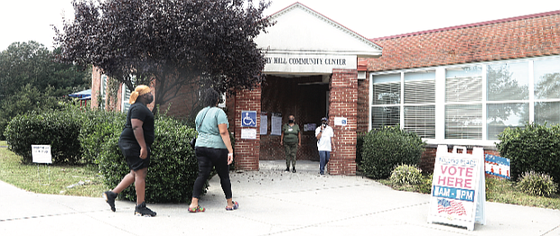 Richmonders heading into Hickory Hill Community Center on Tuesday are greeted by two poll workers outside the early voting location at 3000 E. Belt Blvd. in South Side. The community center and City Hall in Downtown opened Tuesday for early voting for the Nov. 2 election following action by the city Electoral Board. Voters also can cast ballots at the city Voter Registrar’s Office at 2134 W. Laburnum Ave.